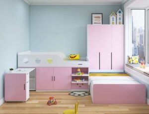 Happy child studying at the desk of their new loft bed.