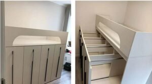 Compact gray fabric sofa bed set up as a seating area in a studio apartment living room.