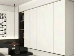 wooden tallboy lingerie chest with five drawers in a modern bedroom.Factory production of a contemporary wooden side cabinet.