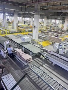 Laser edge banding machine sealing MDF board edges in modern furniture factory