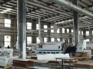 Panel material storage warehouse with organized stacks of plywood, OSB, MDF and particle board