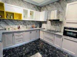 Premium kitchen storage modules with pull-out baskets, corner units and tall pantry cabinets.High-gloss laminate kitchen cabinet with strong metal hinge, close-up shot.