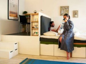 Space-saving bedroom set for small apartments with integrated desk and shelves