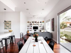 slim sideboard with hidden storage and open shelves used as dining room room divider