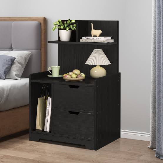 bedroom side tables with drawers in a modern apartment bedroom with lamp, phone, and books