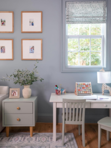 Styled kids bedroom showing night stand beside bed