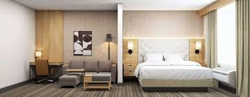 Modern hotel room furnished with factory direct furniture, including a custom-made vanity.