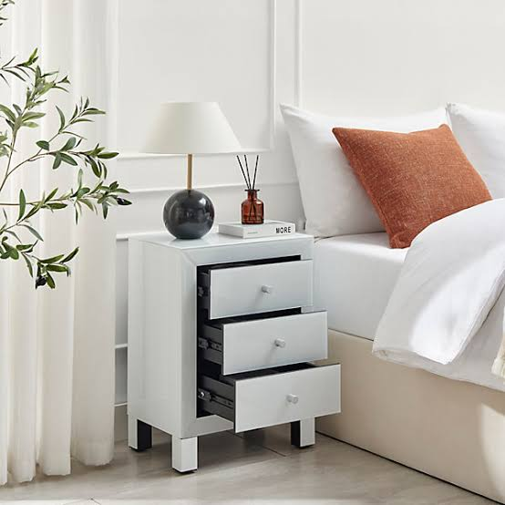 flat-pack bedside cabinet production line with drawer panels, hardware, and assembled sample
