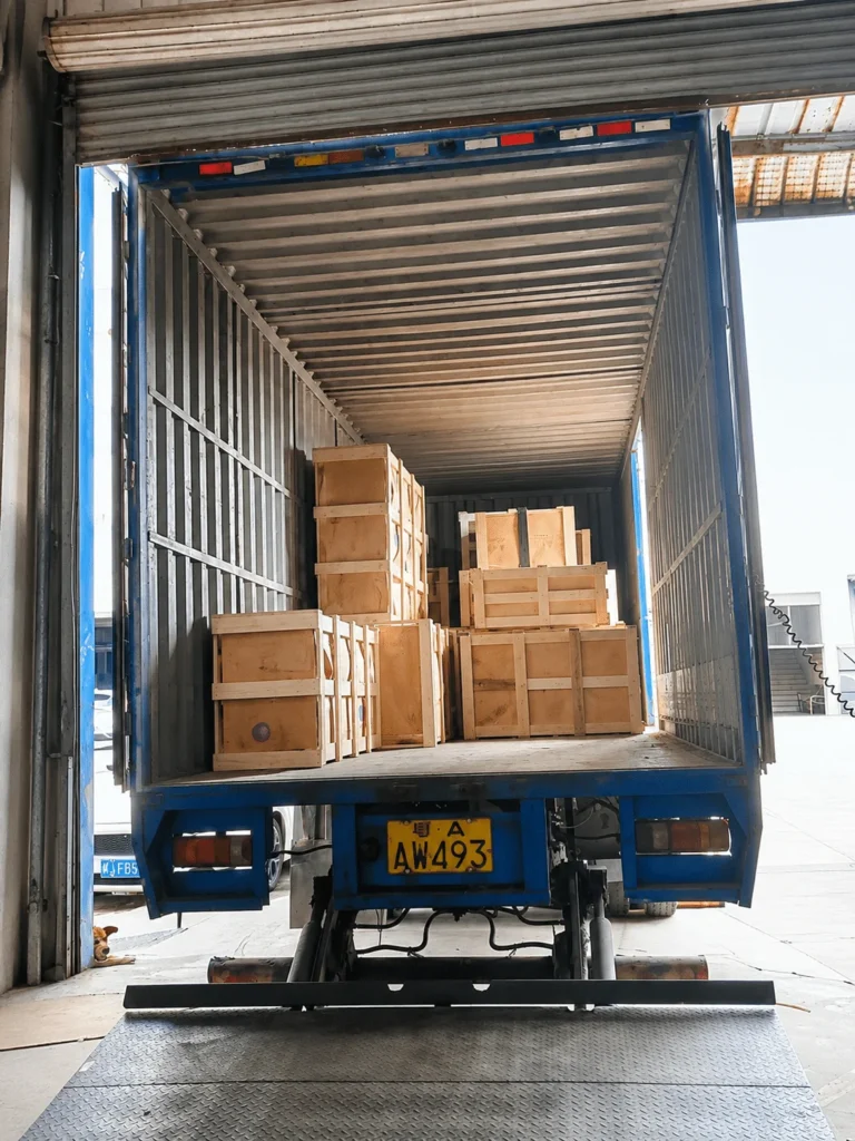 Custom panel furniture packages loaded into a truck for export to the Middle East.
