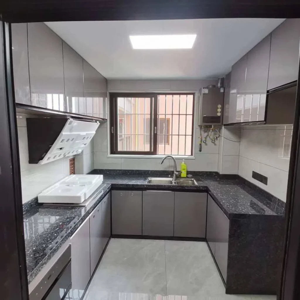 U-shape kitchen cabinet project with white upper cabinets, gray metal-look doors and black quartz countertop