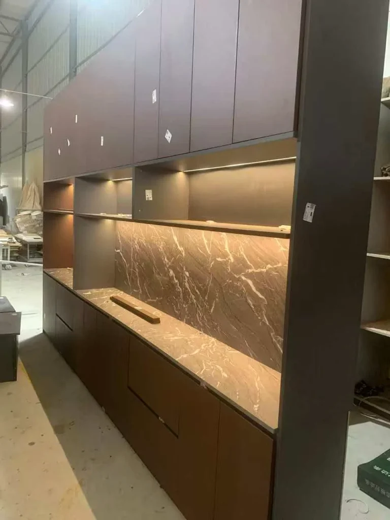 Custom built-in cabinetry with stone-look decorative panels and integrated lighting