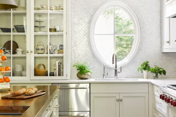Modern kitchen with sleek white cabinets and pull-out drawers, showcasing a minimalist design.