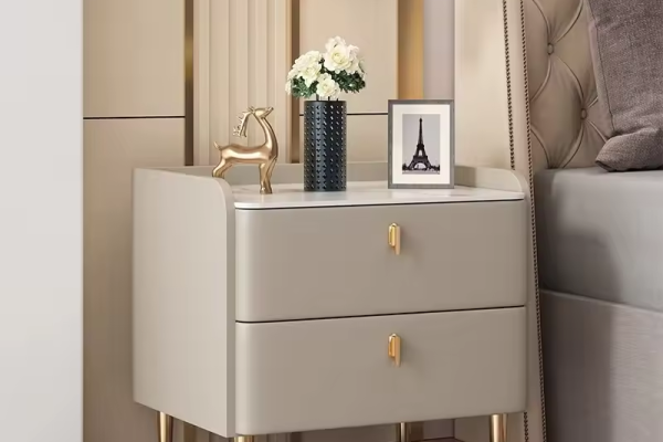 Modern bedside cabinets with drawers in a hotel-style bedroom showing slim and wide nightstand storage options