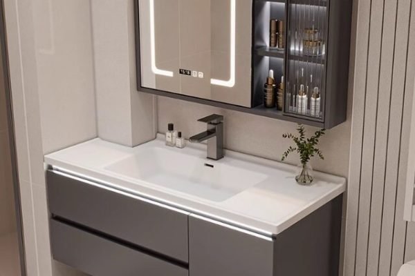 Elegant bathroom vanity with storage drawers and cabinet by.A modern hotel bathroom featuring a floating plywood vanity with backlit mirror.