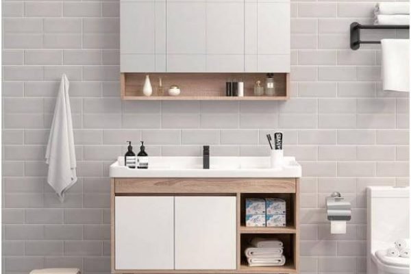 Modern bathroom with a wall-hung plywood vanity, quartz top, and backlit mirror.